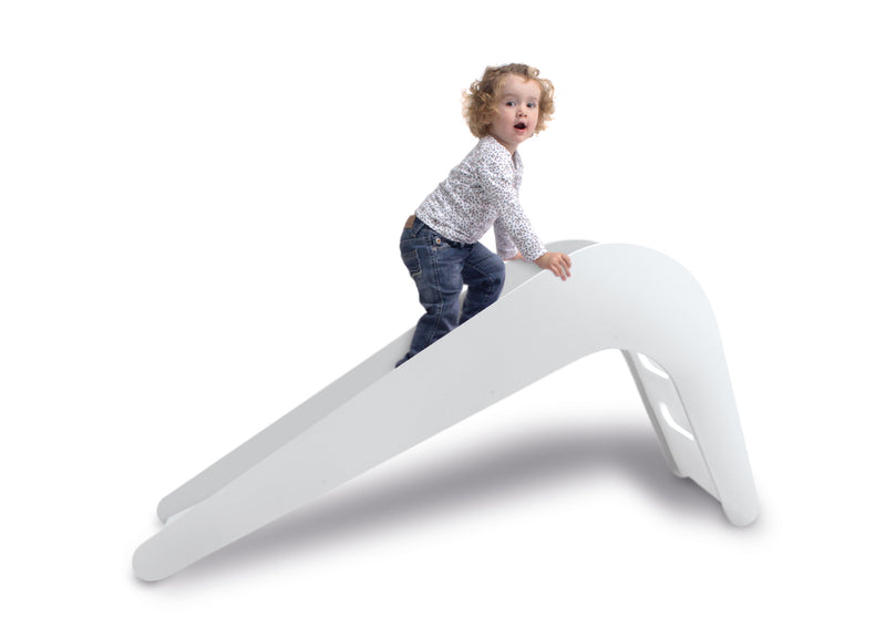 child climbing on jupiduu indoor wooden slide in white