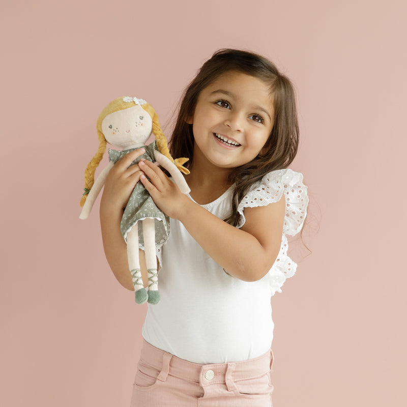 girl holding little dutch julia doll
