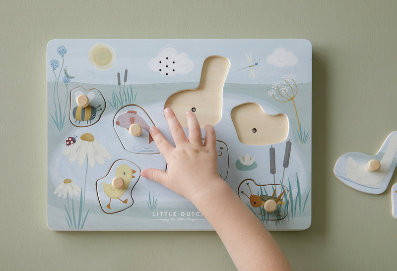 little dutch goose sound board puzzle with child's hand playing