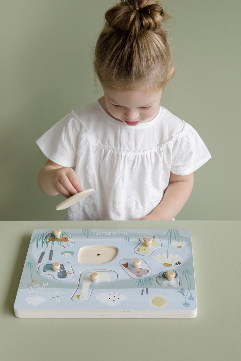 girl playing with little dutch goose sound board puzzle
