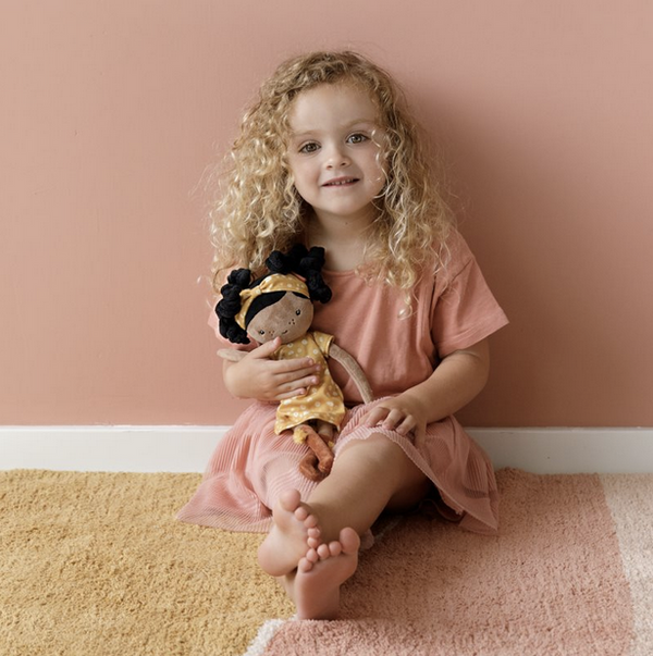 little girl holding little dutch evi doll