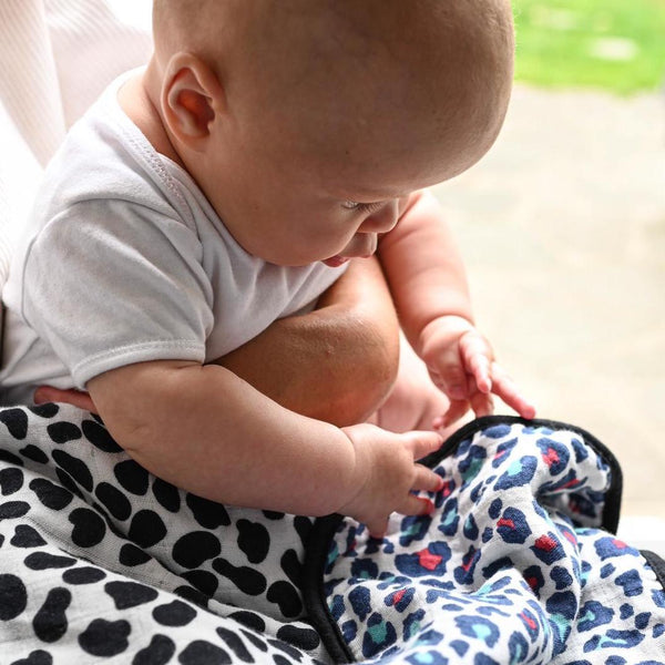 Baby with Etta Loves Animal Print Muslin Blanket